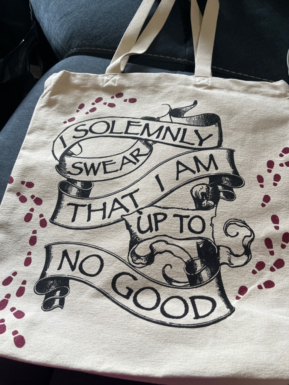 Warner Bros. Cream Tote Bag with Black Script and Maroon Footprints